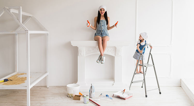 Femme assise sur coffrage de cheminée condamnée dans appartement en travaux